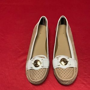 Cream and tan Tommy Hilfiger loafers size 9.5 with logo strap on top. Never worn